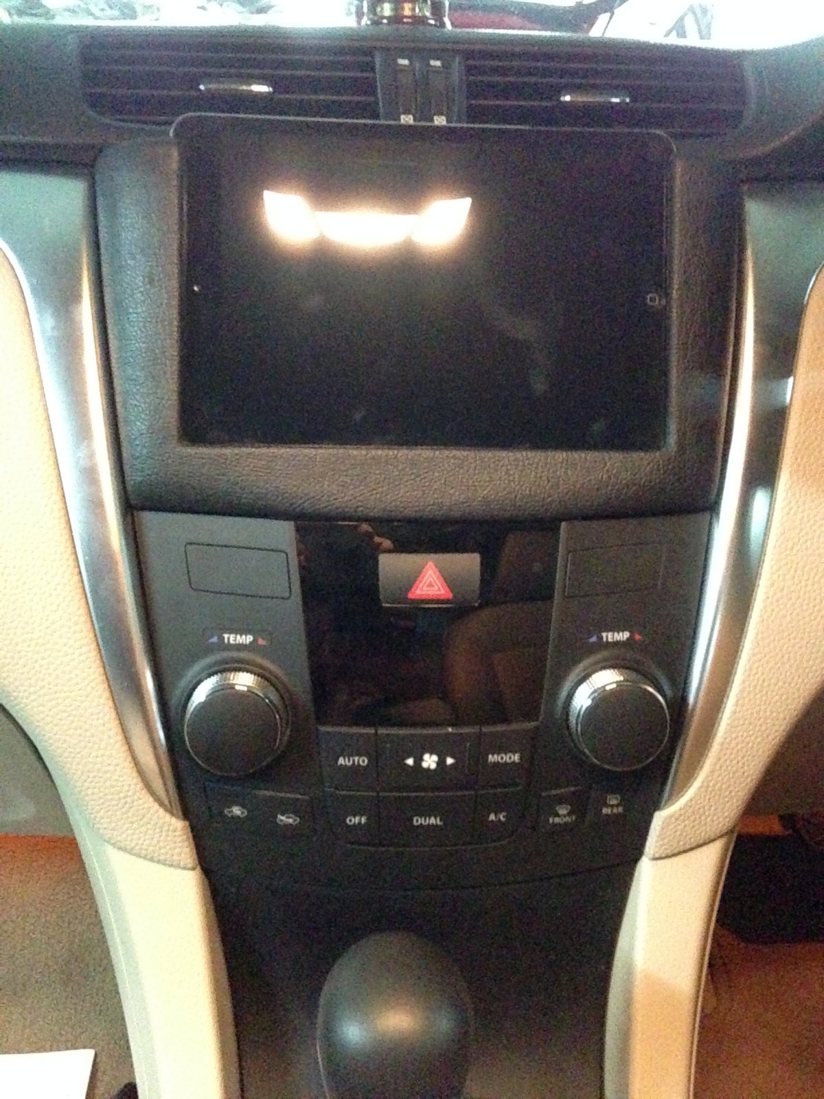 Ipad mini Installed in the dash . the mount was made in wood and leather wrapped to match the texture of the dash.